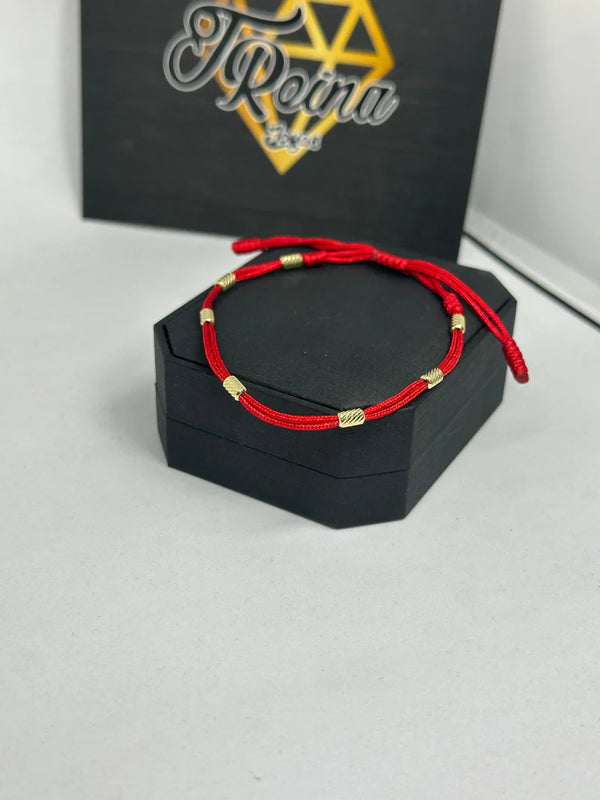 PULSERA 7 NUDOS  HILO ROJO 0,62GR NACI ORO 18KT